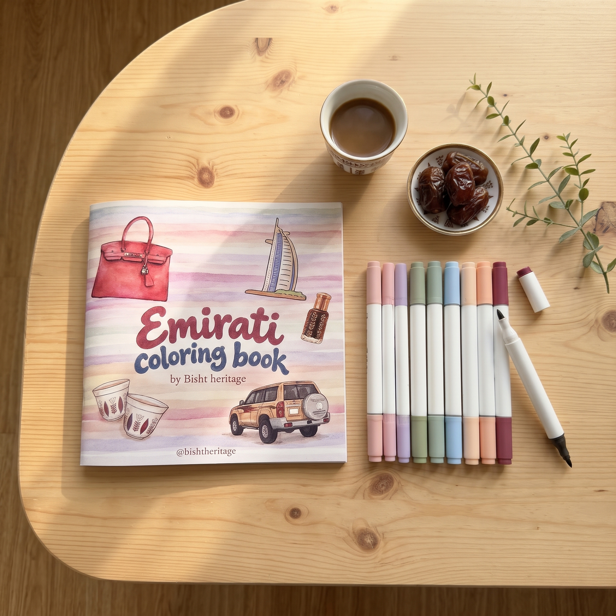 Emirati Coloring Book flat lay with marker pens and Arabic coffee
